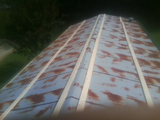 Rusted metal roof panels with new wood purlins before replacement — Storm Damage Roof Repair in Conway Springs by Roofing Brothers