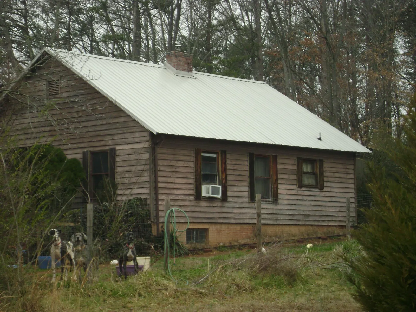 White metal roof on an old wood sided farmhouse, from a Metal Roof Installation job in Conway Springs